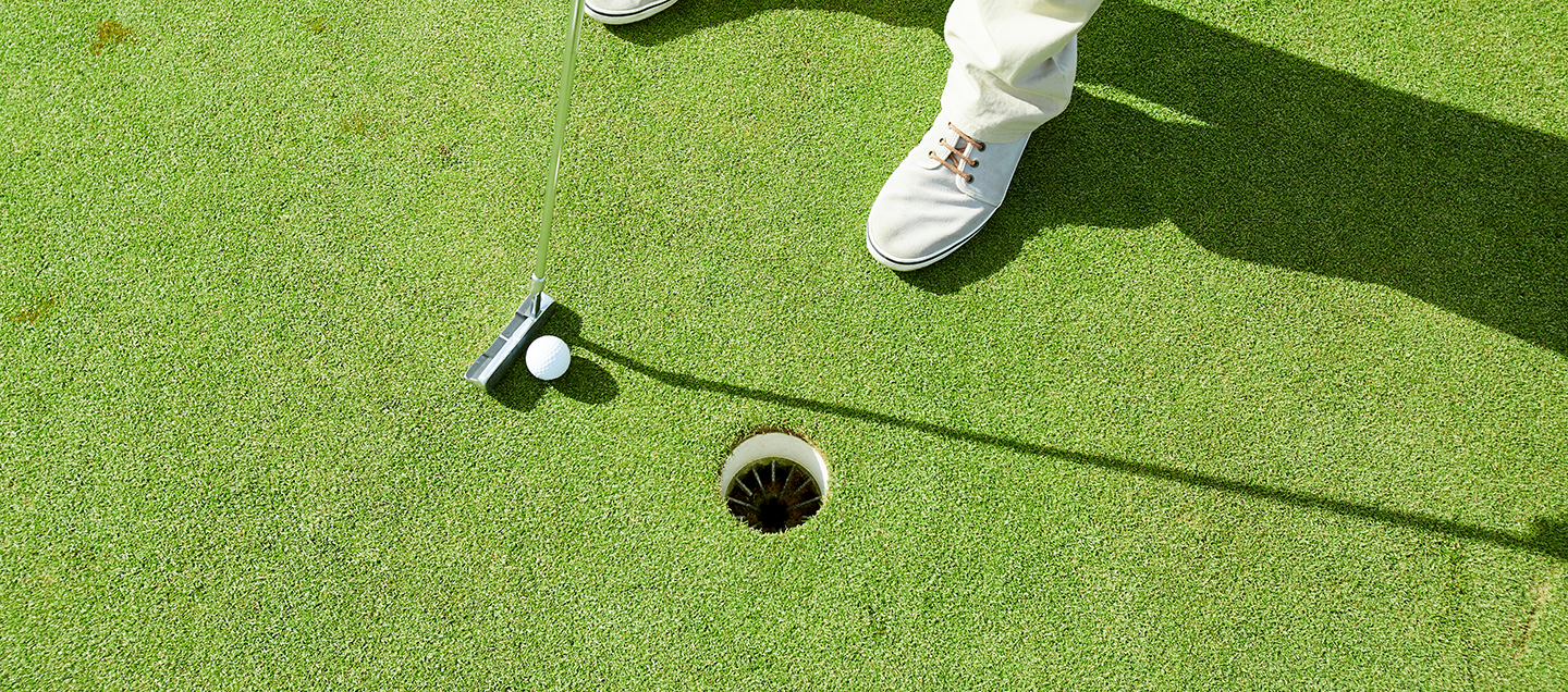 Image of a putting green with a golf ball